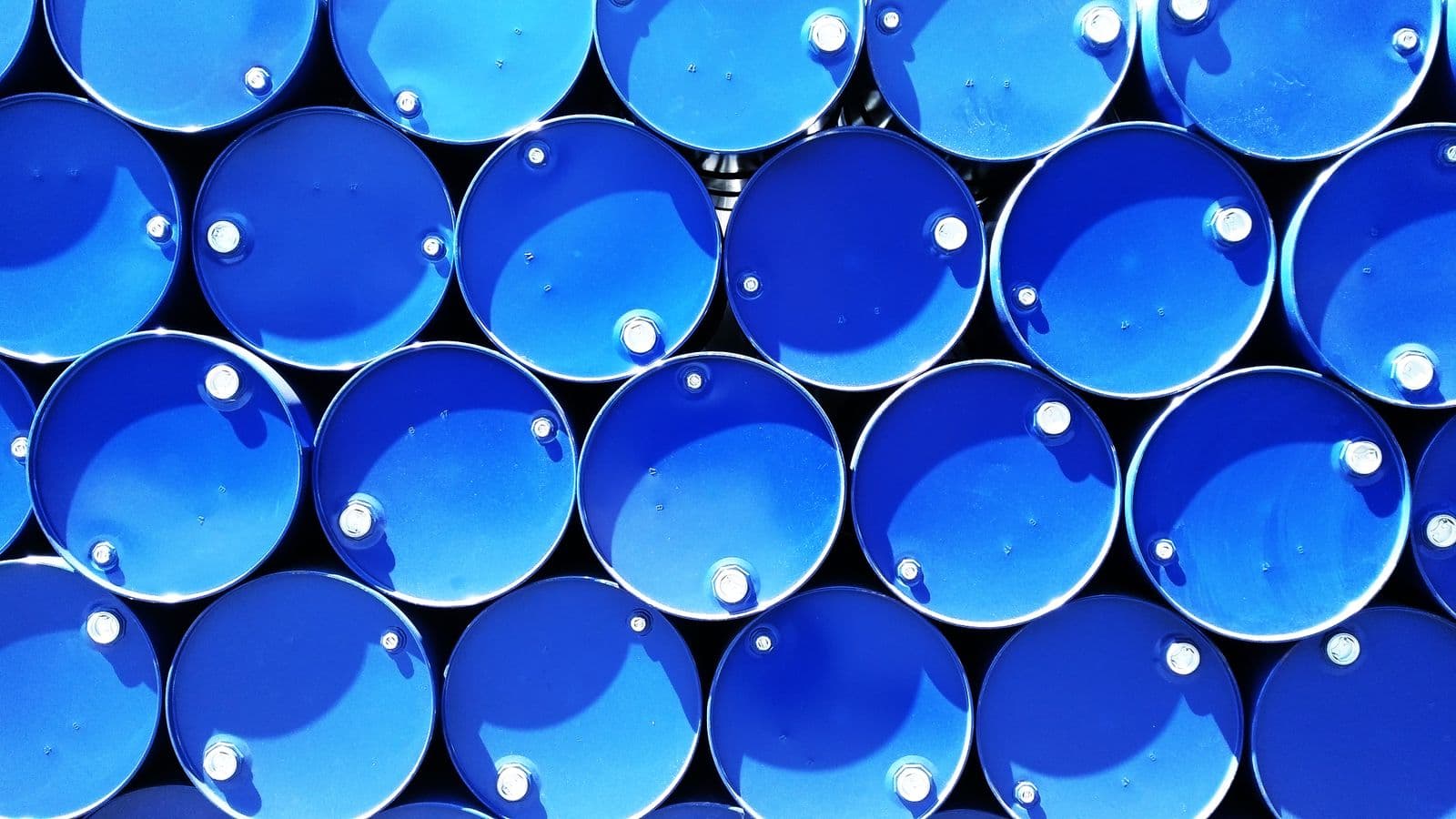 Sealed steel drums stacked and viewed from directly above.
