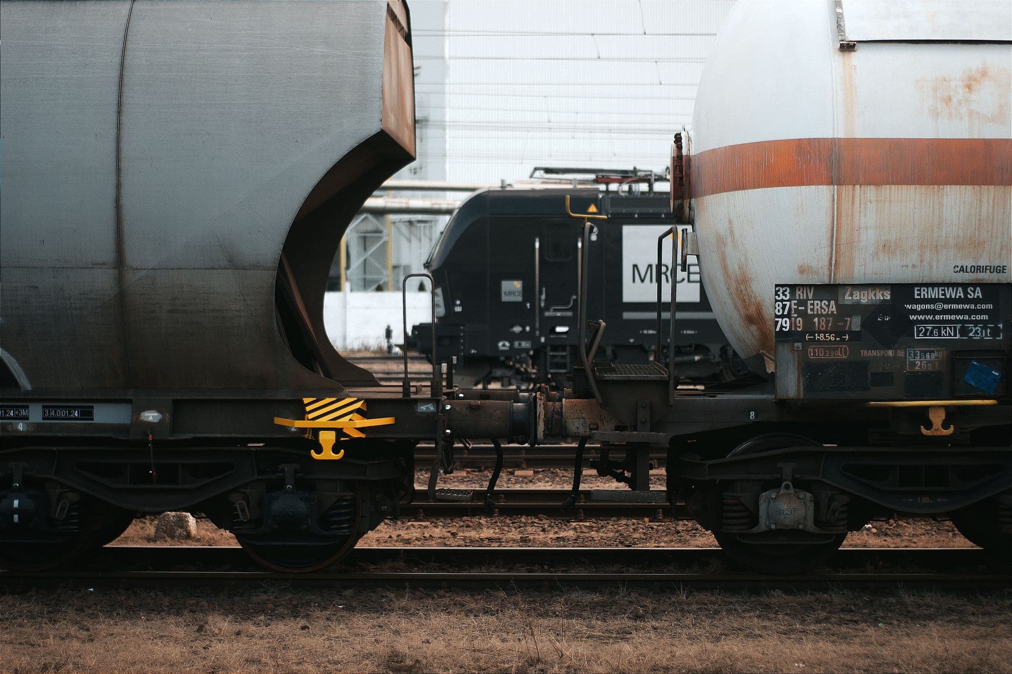 Rail tank wagons coupled in a freight yard.
